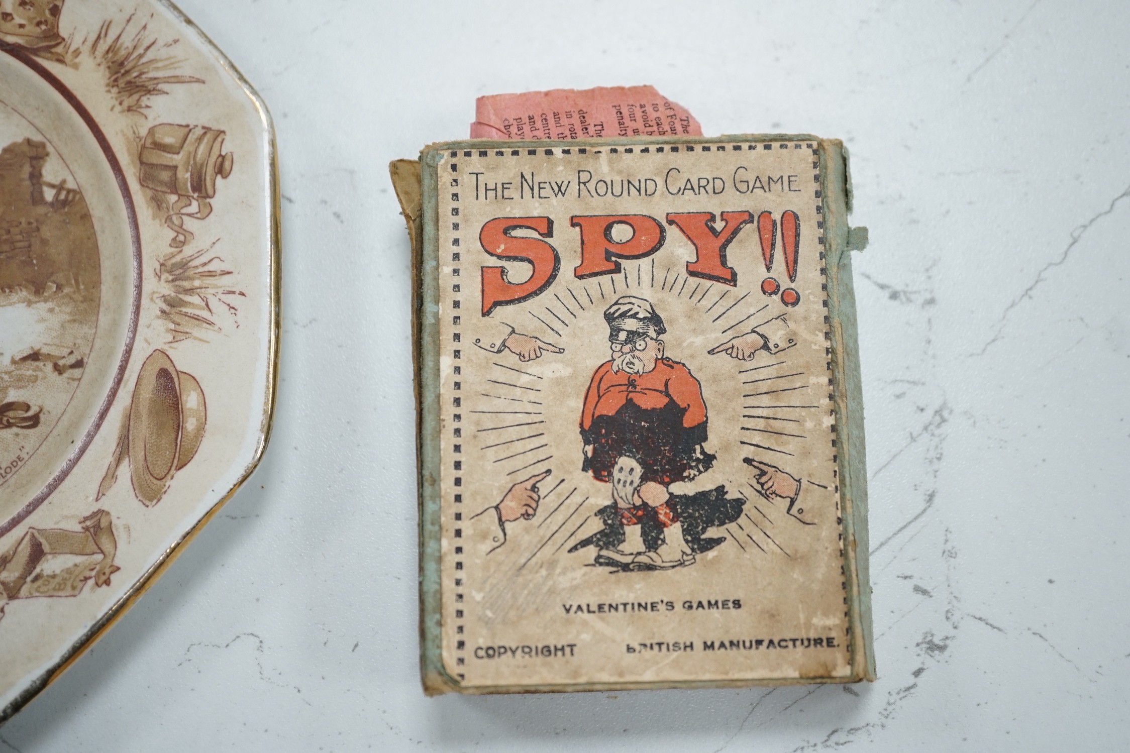 WWI commemorative Grimwades ‘Old Bill’ ceramics, including a jug, a bowl, five various dishes and a moustache cup and saucer, together with two novelty character jugs and a spy card game